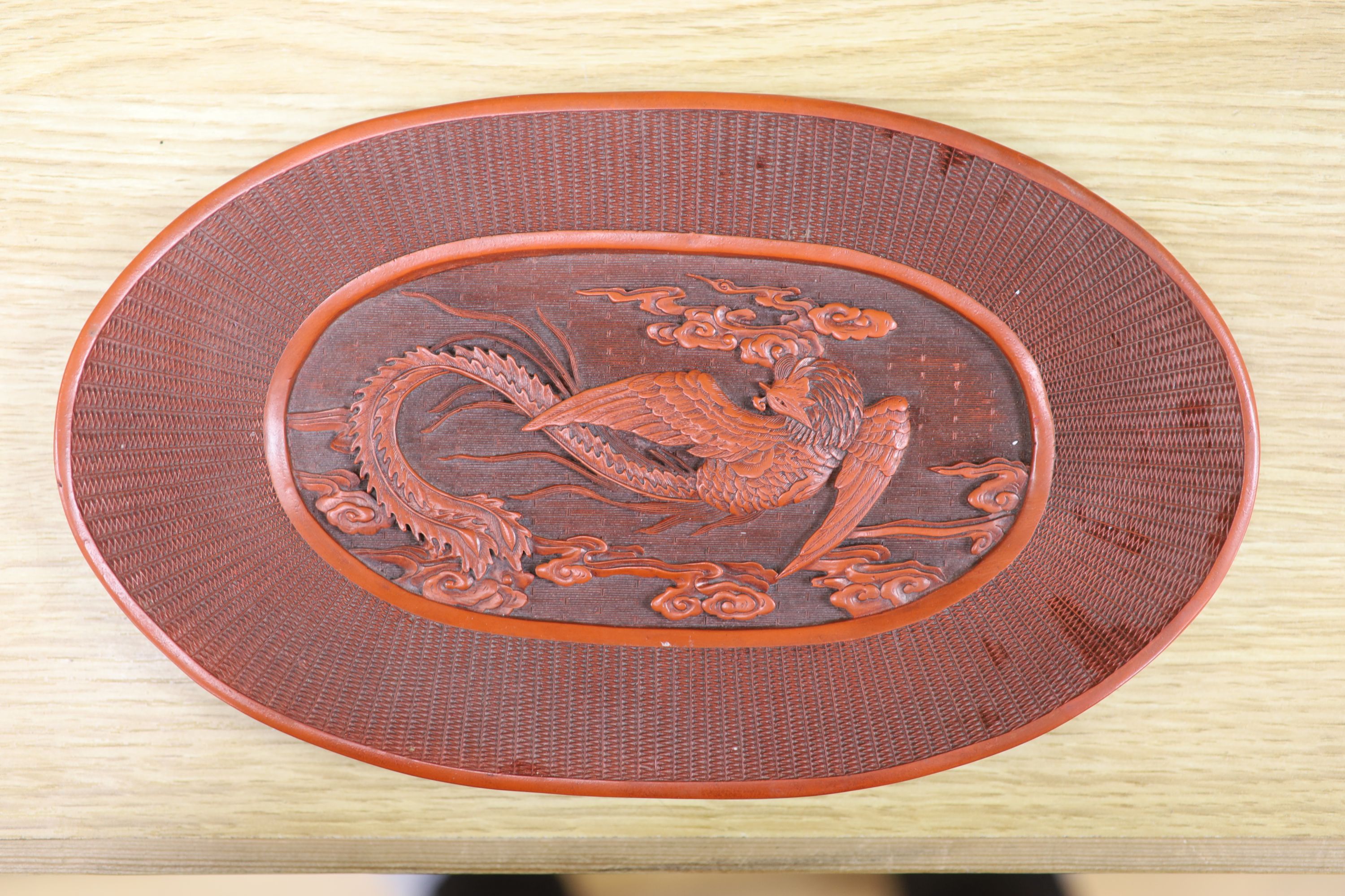 A Chinese lacquer and composition dish and a bronze hand warmer, length 27cm